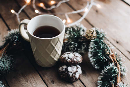 Christmas styled composition. Winter still life. Scandinavian hygge concept. Morning concept. Cozy winter scene with hot tea or coffee and cookies. Flat lay. Home decor.の写真素材