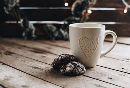 Christmas styled composition. Winter still life. Scandinavian hygge concept. Morning concept. Cozy winter scene with hot tea or coffee and cookies. Flat lay. Home decor.の写真素材