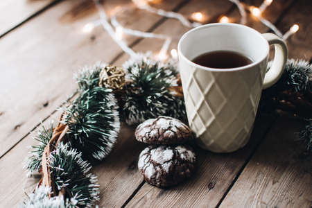 Christmas styled composition. Winter still life. Scandinavian hygge concept. Morning concept. Cozy winter scene with hot tea or coffee and cookies. Flat lay. Home decor.の写真素材