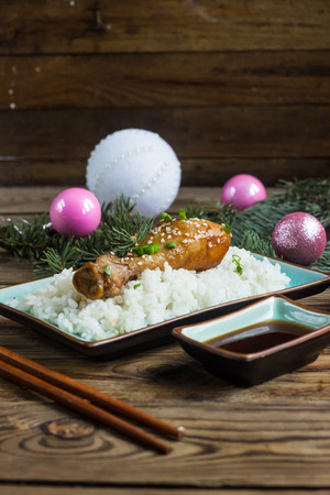 Chicken teriyaki legs and rice on wood background. Selective focusの写真素材