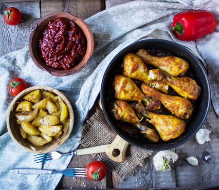 
chicken legs , baked potatoes , homemade sauce " barbecue "の写真素材