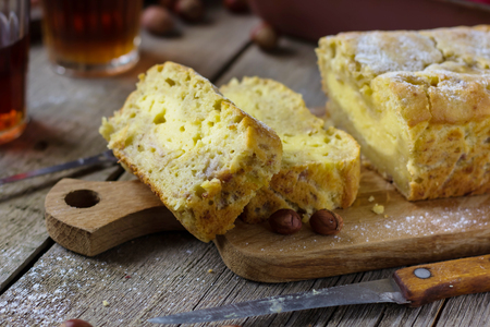 Homemade Banana Bread whith cream cheese cut in slices on rustic wooden background. Selective focusの写真素材