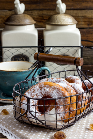 Fresh donuts and coffee on wood background. Selective focusの写真素材