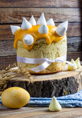 Easter composition of sweet cake and eggs on wooden background. Orthodox kulich.  Selective focus