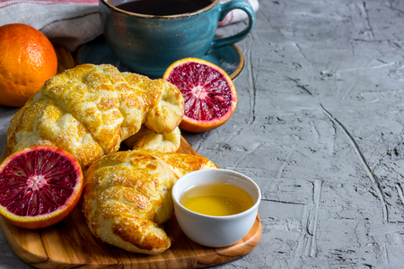 Homemade chocolate sweet croissant on wooden cutting board.  Selective focus. Copy spaceの写真素材