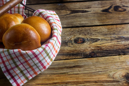 Russian pirozhki on wooden table. Baked patties stuffed with cabbage. Selective focus
