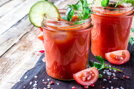 Bloody Mary cocktail. Alcoholic drink and ingredients on wooden table. Copy space. Selective focusの写真素材
