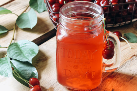 cherry lemonade in jar on a wooden table. Selective focus. Toned