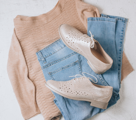 Autumn Arrives. Women fashion cloth and accessories. Trendy Cozy Jumper. Flat lay. Vanilla Pastel colors.の写真素材