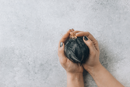 Woman holding christmas black ball to decorate christmas tree.の写真素材