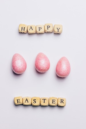 Happy Easter greeting card with wooden letters and egg on whiteの写真素材