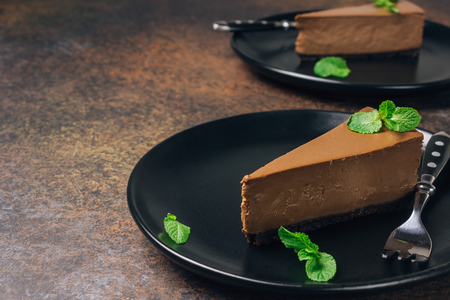 chocolate or coffee cheesecake with glaze and mintの写真素材