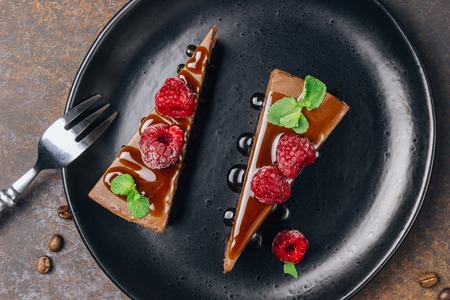chocolate or coffee cheesecake with glaze, mint and raspberryの写真素材