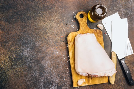 Raw pork knuckle on an cutting board. Rustic style. Selective focusの写真素材
