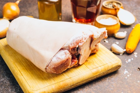 Raw pork knuckle on an cutting board. Rustic style. Selective focusの写真素材