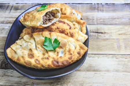 Latin American homemade fried empanadas with tomato sauces on wooden background. Selective focusの写真素材