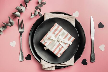 Valentines day or wedding meal background. Romantic holiday table setting. Black and pink table setting. Flat layの写真素材