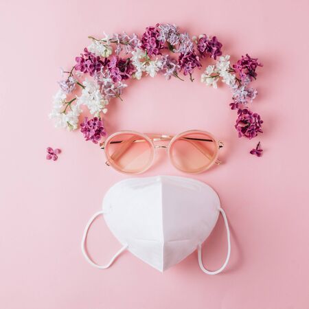 Poker face and keep positive) White KN95 mask with sunglasses and flowers in the shape of hair on pinkの写真素材