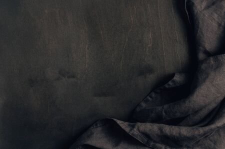 Black table setting napkin on black woodenの写真素材
