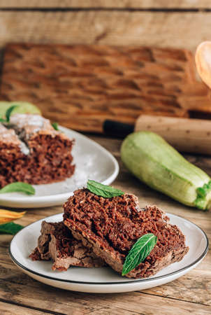Vegan crunchy chocolate zucchini cake on rustic wooden. Healthy gluten free food. Selective focus. Vertical photoの写真素材