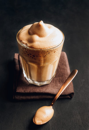 Whipped instant coffee. New popular food and drink trend. One glass of Korean Dalgona coffee with...