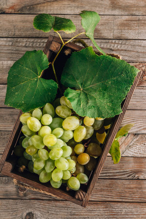 White grapes in a wooden box on rustic wooden background.の写真素材