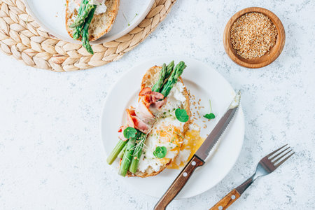 Sandwitch with Asparagus, egg, bacon on white tile background. Tasty breakfast toast. top viewの写真素材