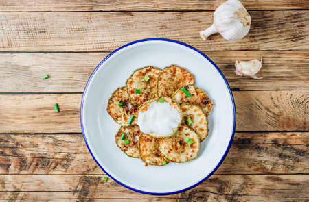 Breaded zucchini with garlic sauce on rustic wooden background. top view with copy spaceの写真素材