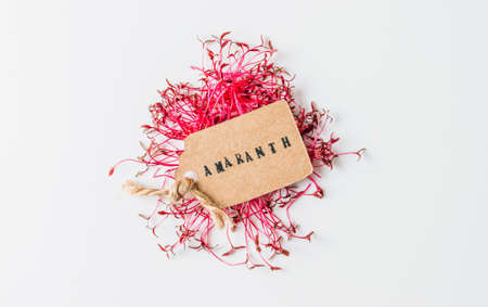 Organic freshly amaranth leaves with paper label on white backgroundの写真素材