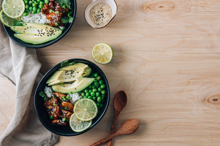 Buddha bowl with crispy sesame chicken asian style. Sweet and sour fried chicken with steamed rice, peas and acocadoの写真素材
