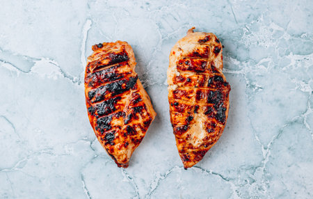 Grilled chicken fillets on gray marble background. Top view. Protein food.の写真素材