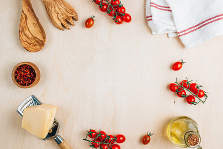 Food cooking background. Food frame on wooden table. Fresh tomato, spices, cheese and oil. Ingredients for cooking with space for your text.の写真素材