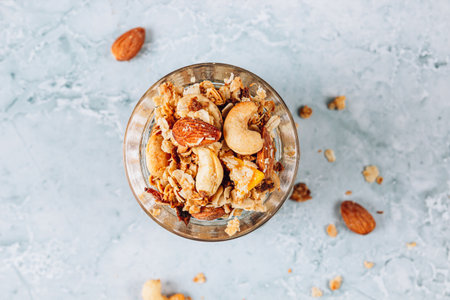 Healthy oatmel granola baked with nuts, coconut oil and honey in a jar.の写真素材