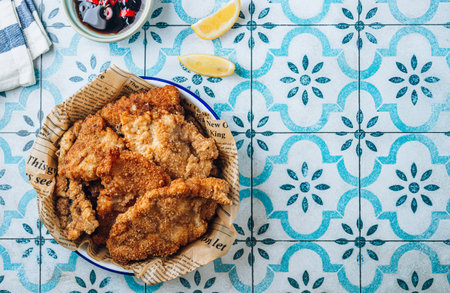 Breaded fried squid chops with spicy sauce and lemonの写真素材