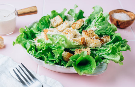Traditional caesar salad with lettuce, wheat croutons, parmesan and sauce.の写真素材