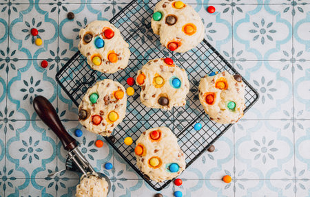 Freshly baked cookies with colorful candy-coated chocolatesの写真素材