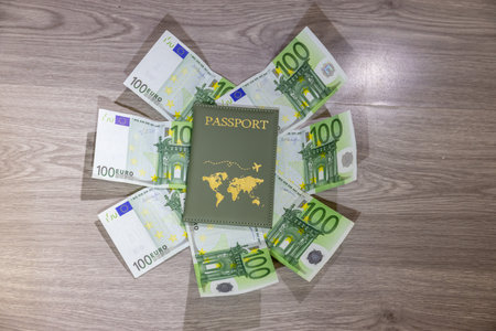Euro bills and passport on wooden table. Travel and tourism concept.の写真素材