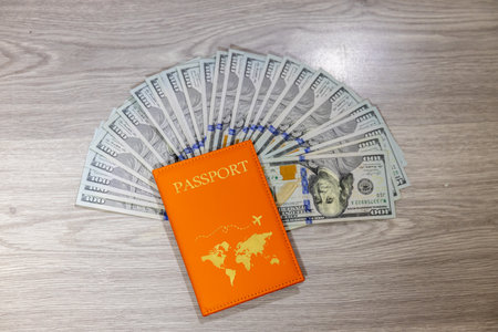 passport and money on a wooden table, travel concept, top viewの写真素材
