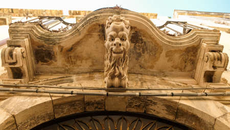Ortigia island, Sicily. Unusual balcony decoration, with a scary head on it.の写真素材