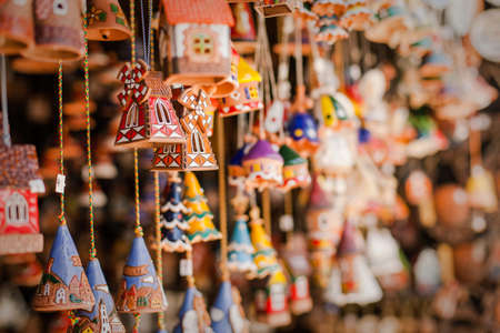 Souvenir ceramic bells and toy houses at the market, local national craftの写真素材