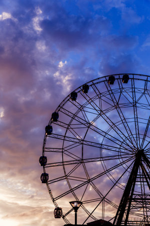 Ferris wheel against a bright beautiful sunset skyの写真素材