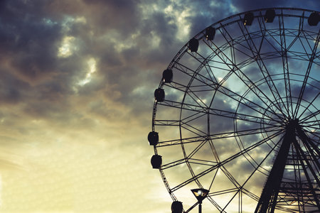 Ferris wheel against a bright beautiful sunset skyの写真素材