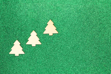 Three fir trees on a shiny green background. Concept: Christmas backdropの写真素材