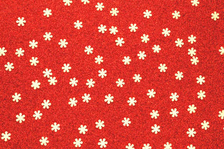 Snowflakes on a red shiny backdrop. Christmas background. Concept: flying snowの写真素材