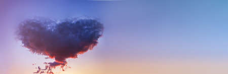 A large heart-shaped cloud in the sky after sunset. Banner.の写真素材