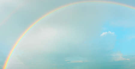 Rainbow on the background of a clear blue sky.の写真素材