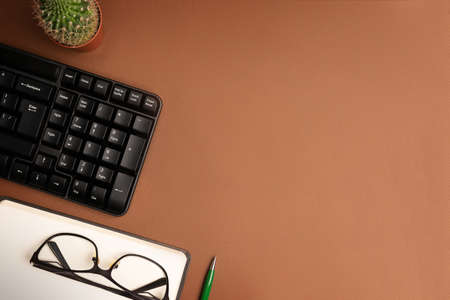 A workspace with stationery on a brown background. Concept: freelance, work from home.の写真素材