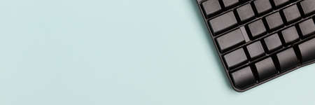 Laptop keyboard on a blue background. Concept: freelance, work from home.の写真素材