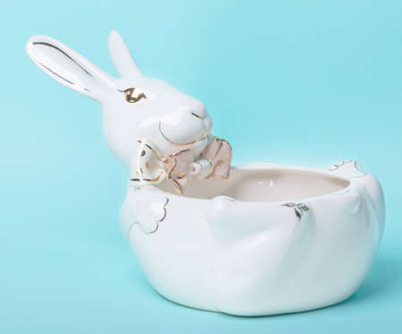 White ceramic plate in the shape of a rabbit on a blue background.の写真素材