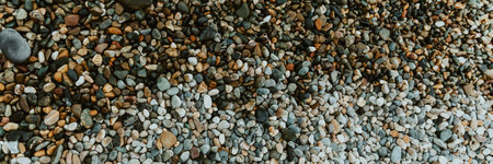 Blue pebbles on the beach. Great natural background for your design. Top view. Banner. Selective...